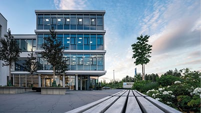 Modern glass office building of the KOCH headquarters in Pfalzgrafenweiler, seen in evening light