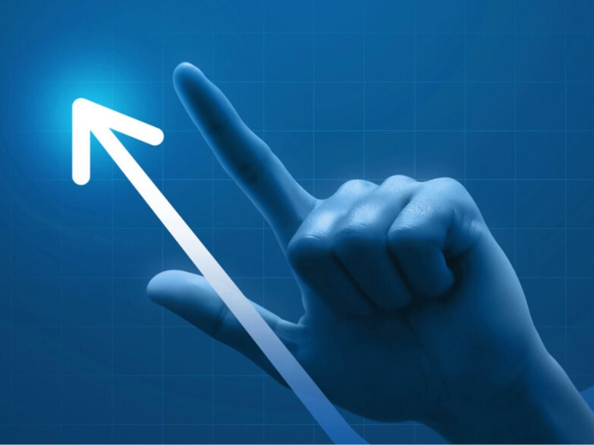Hand with index finger pointing upward alongside a white upward arrow on a blue background