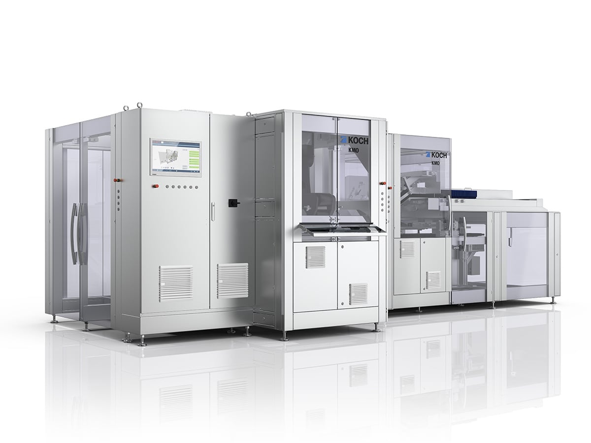 KMO modular machine at an angle, control cabinet with touchscreen and a row of glazed process modules