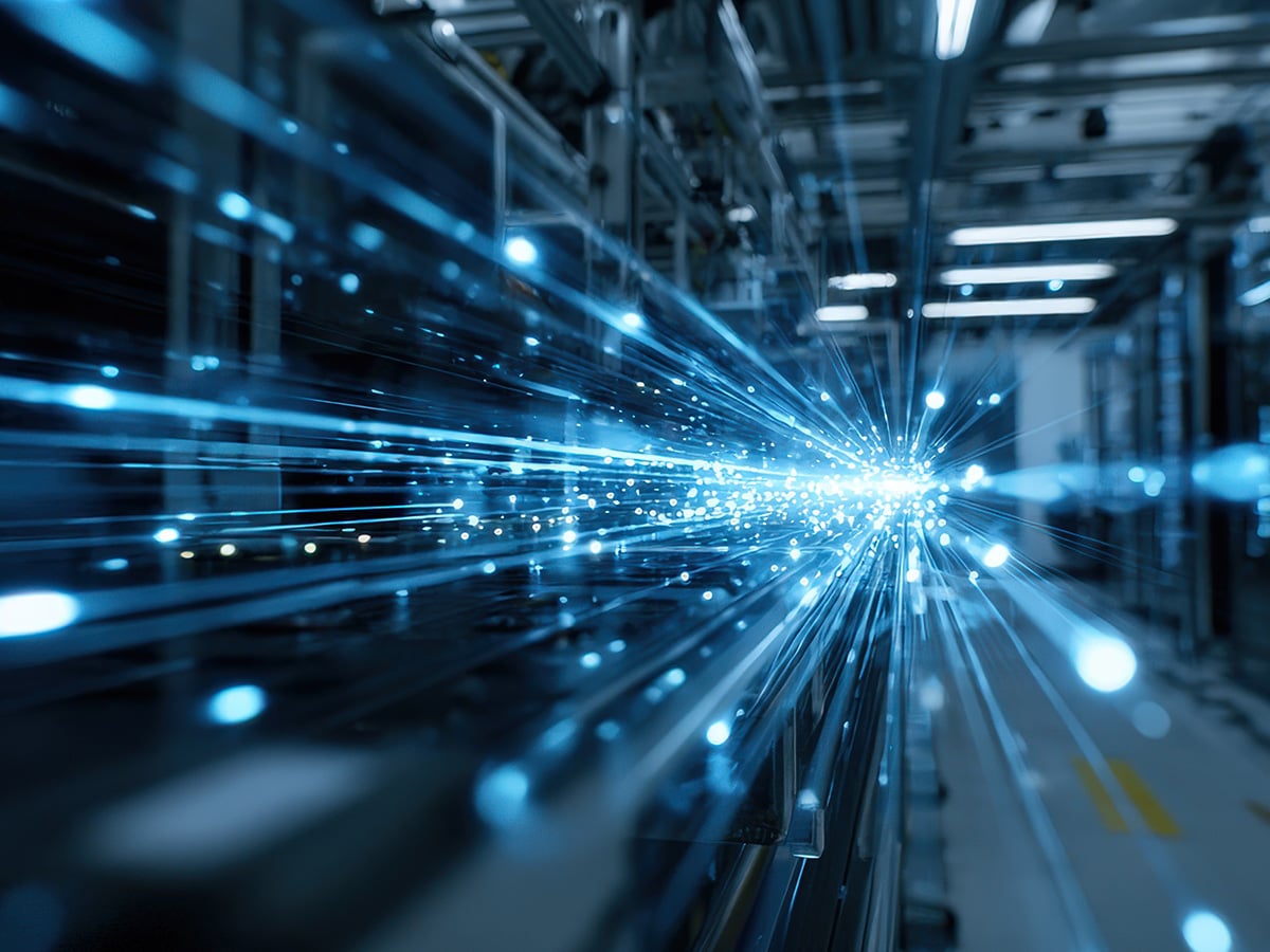 Abstract illustration of converging blue light streams in an industrial setting, symbolising digital connectivity