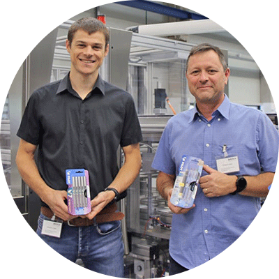Portrait of Philippe Leleu and Sébastien Clatot of PILOT, each holding a blister pack of pens