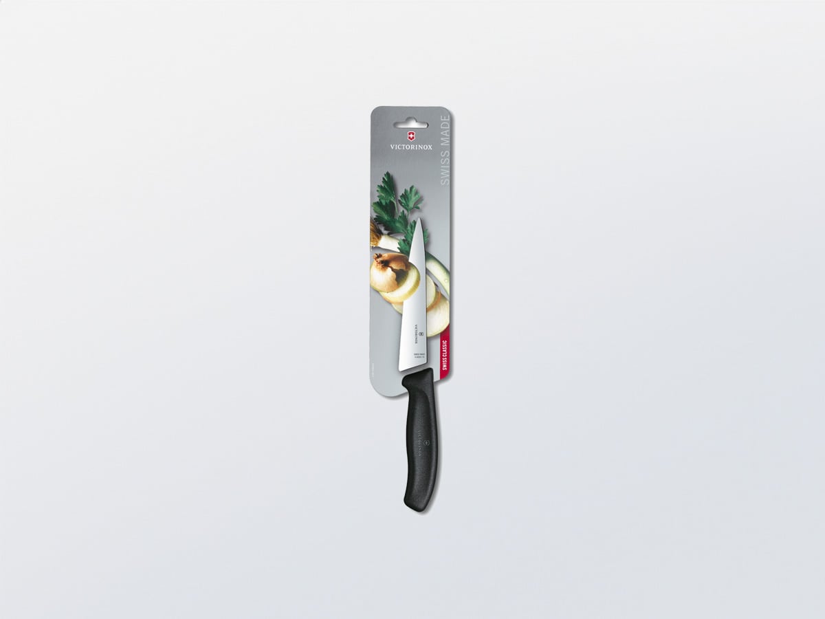 Victorinox kitchen knife with black handle on a narrow printed cardboard backing