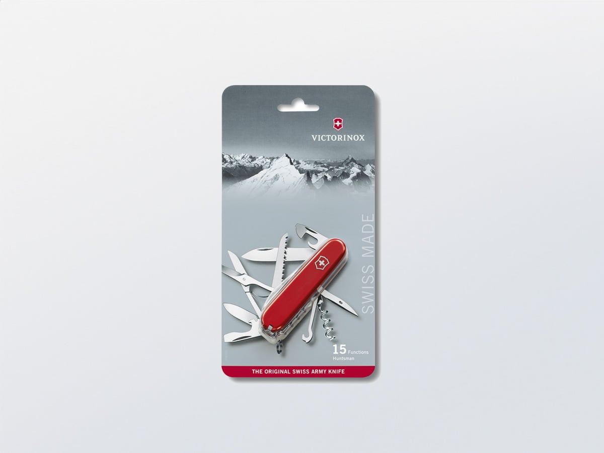 Victorinox Huntsman Swiss Army Knife with 15 functions in a transparent blister on a printed carton card