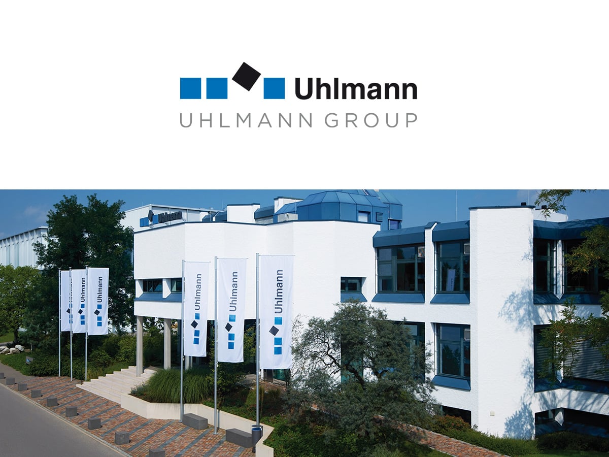 Uhlmann Pac-Systeme headquarters in Laupheim with Uhlmann flags in front, part of the Uhlmann Group network