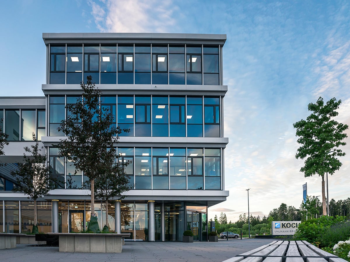 KOCH Pac-Systeme headquarters in Pfalzgrafenweiler at dusk, illustrating the company's sustainability commitments including EcoVadis and UN Global Compact