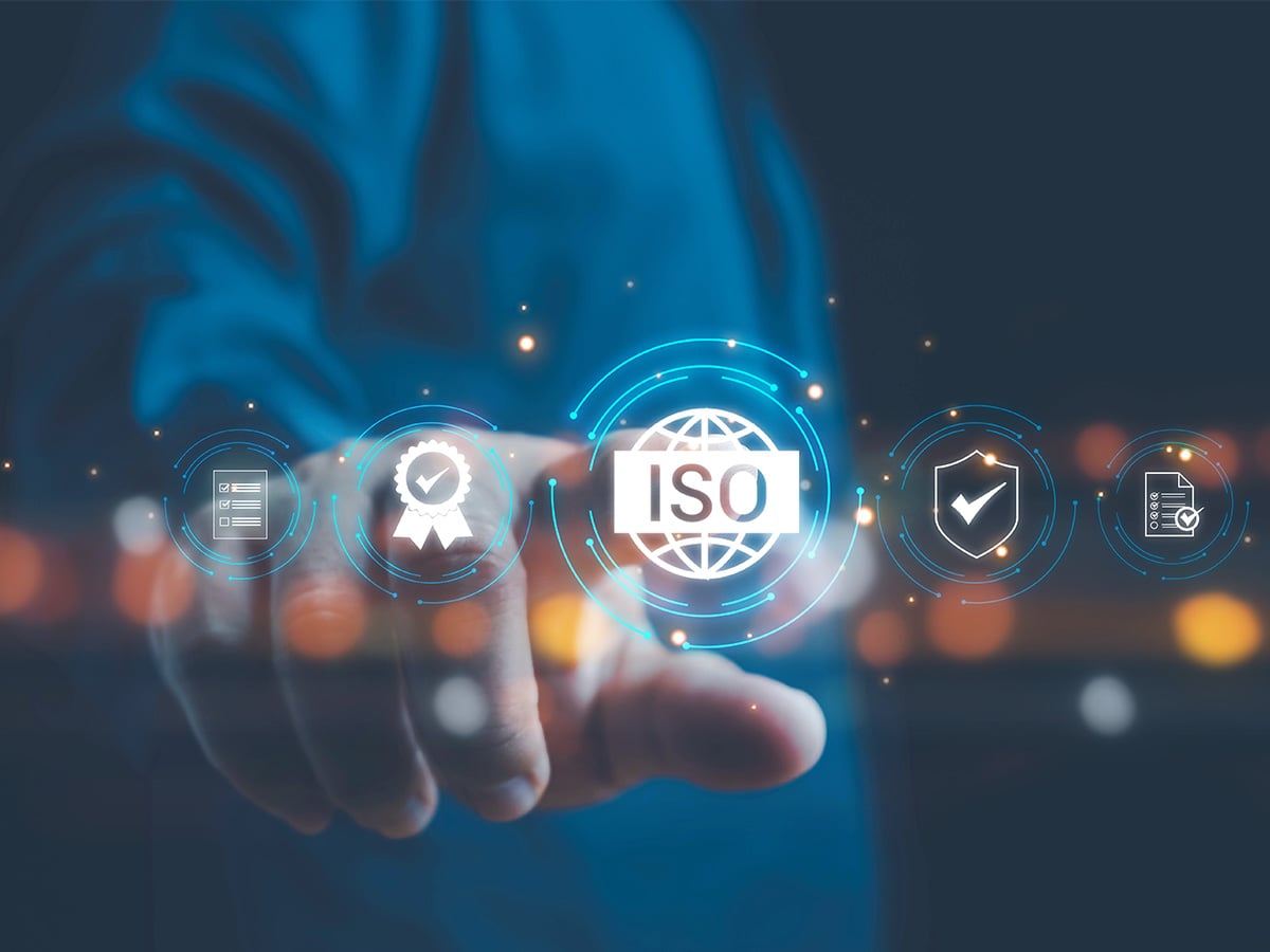 Illustration of a hand holding floating ISO certification icons, symbolising KOCH Pac-Systeme's DIN EN ISO 9001 quality management certification